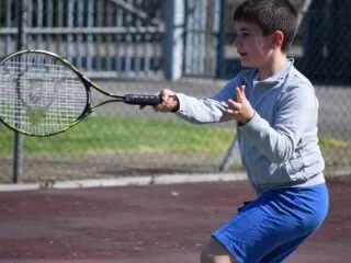 child playing tennis