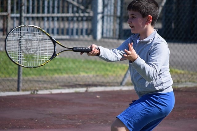 child playing tennis