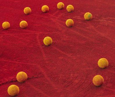 tennis balls on clay court