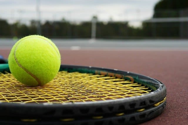 tennis racket with yellow strings