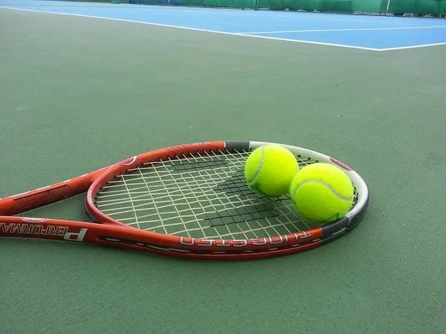 tennis racket with two balls